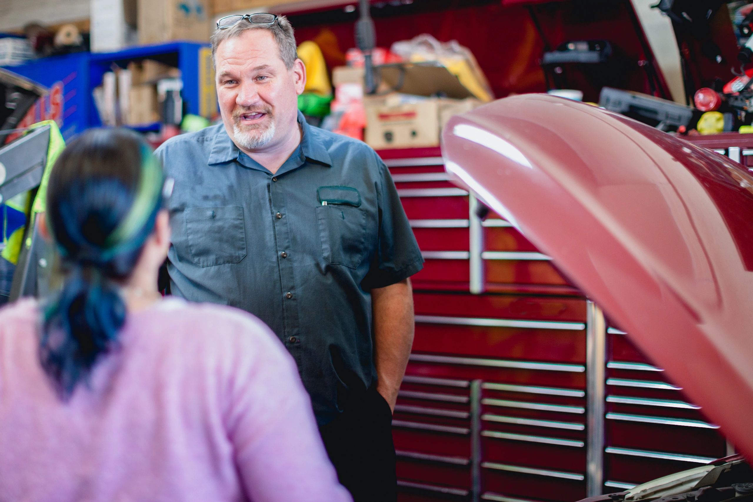 Mechanic discussing service details with a customer