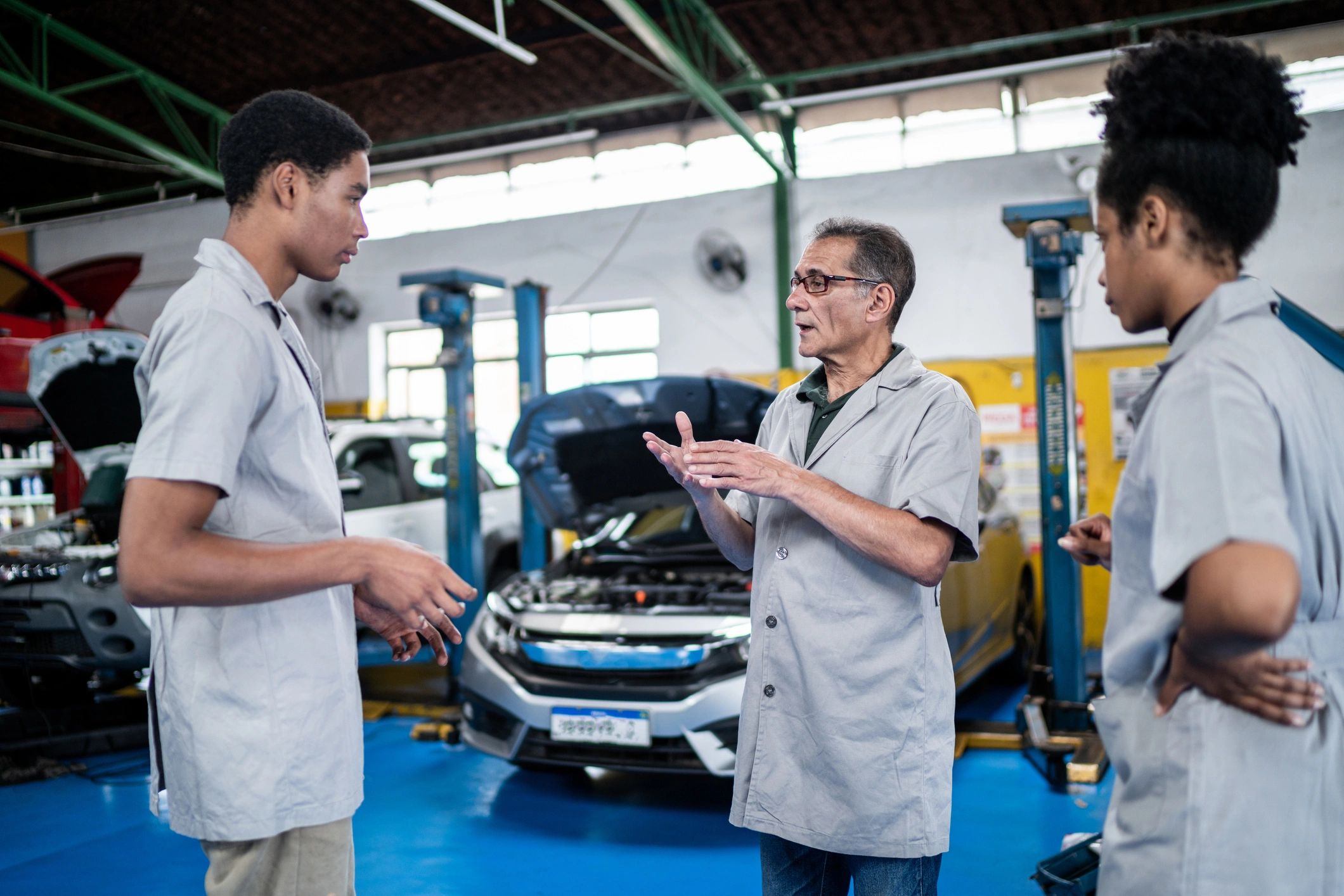 Auto technicians reviewing a vehicle in the shop