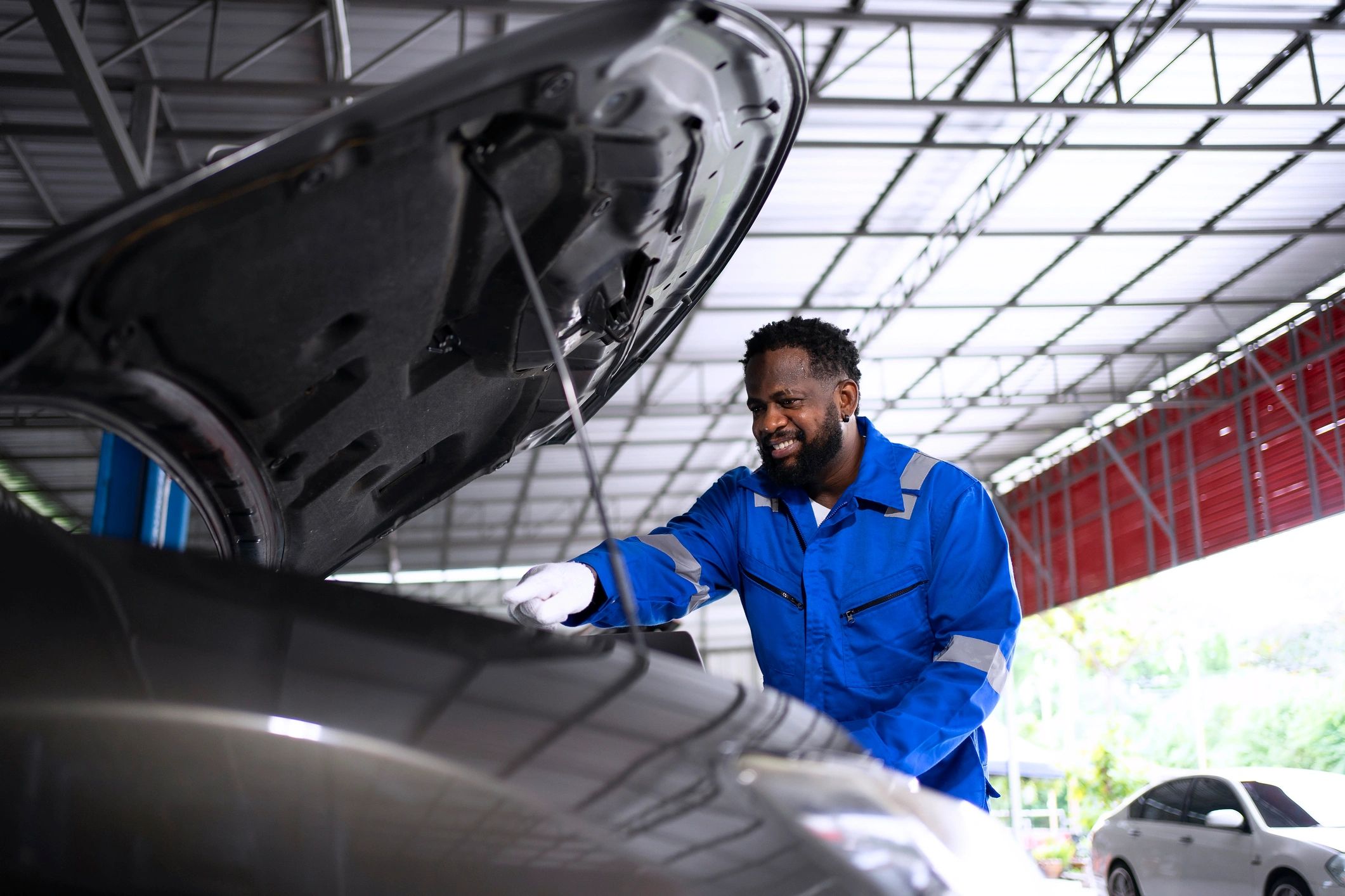 Mechanic performing routine service in an auto repair shop