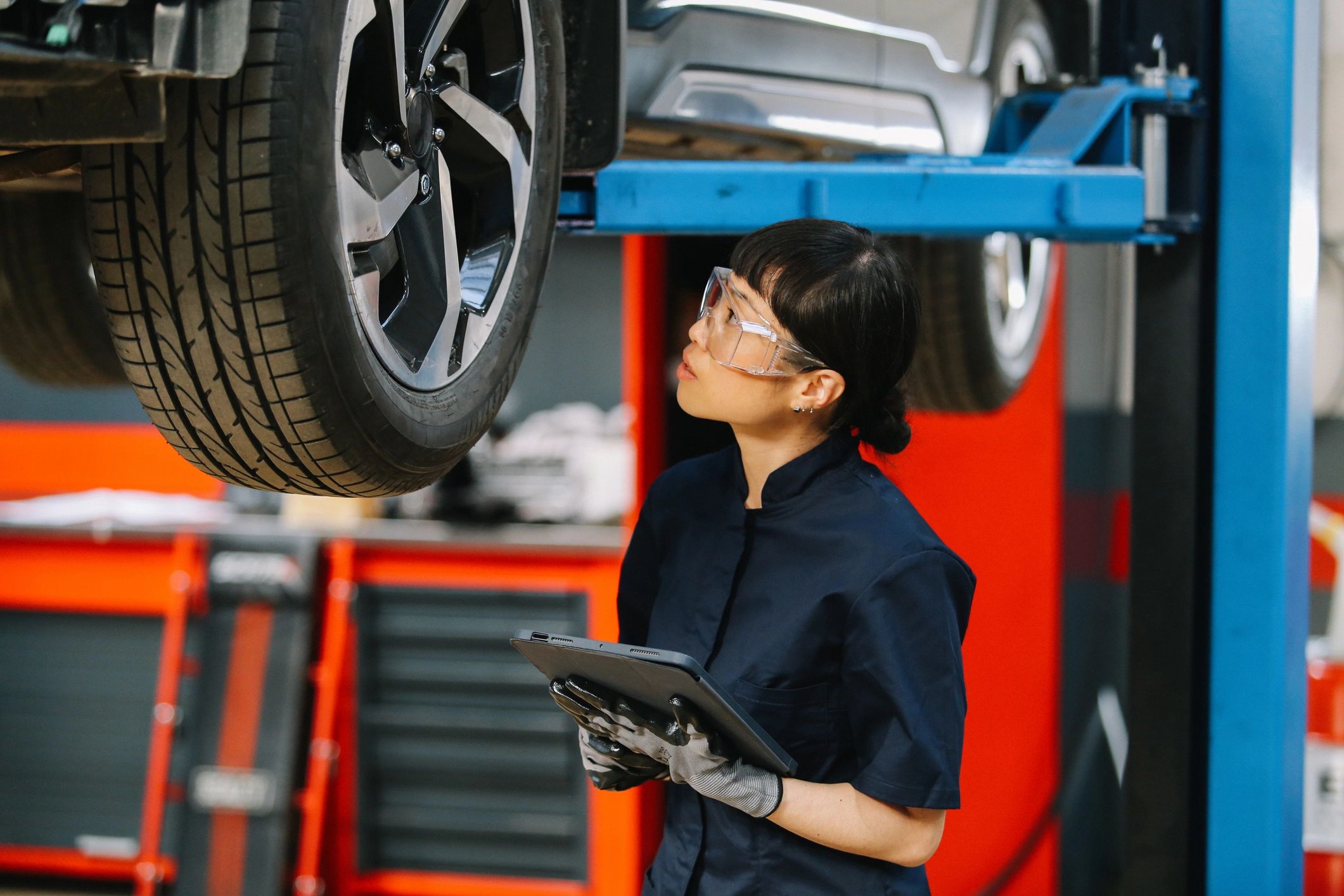 Mechanic inspecting a vehicle in an auto repair shop