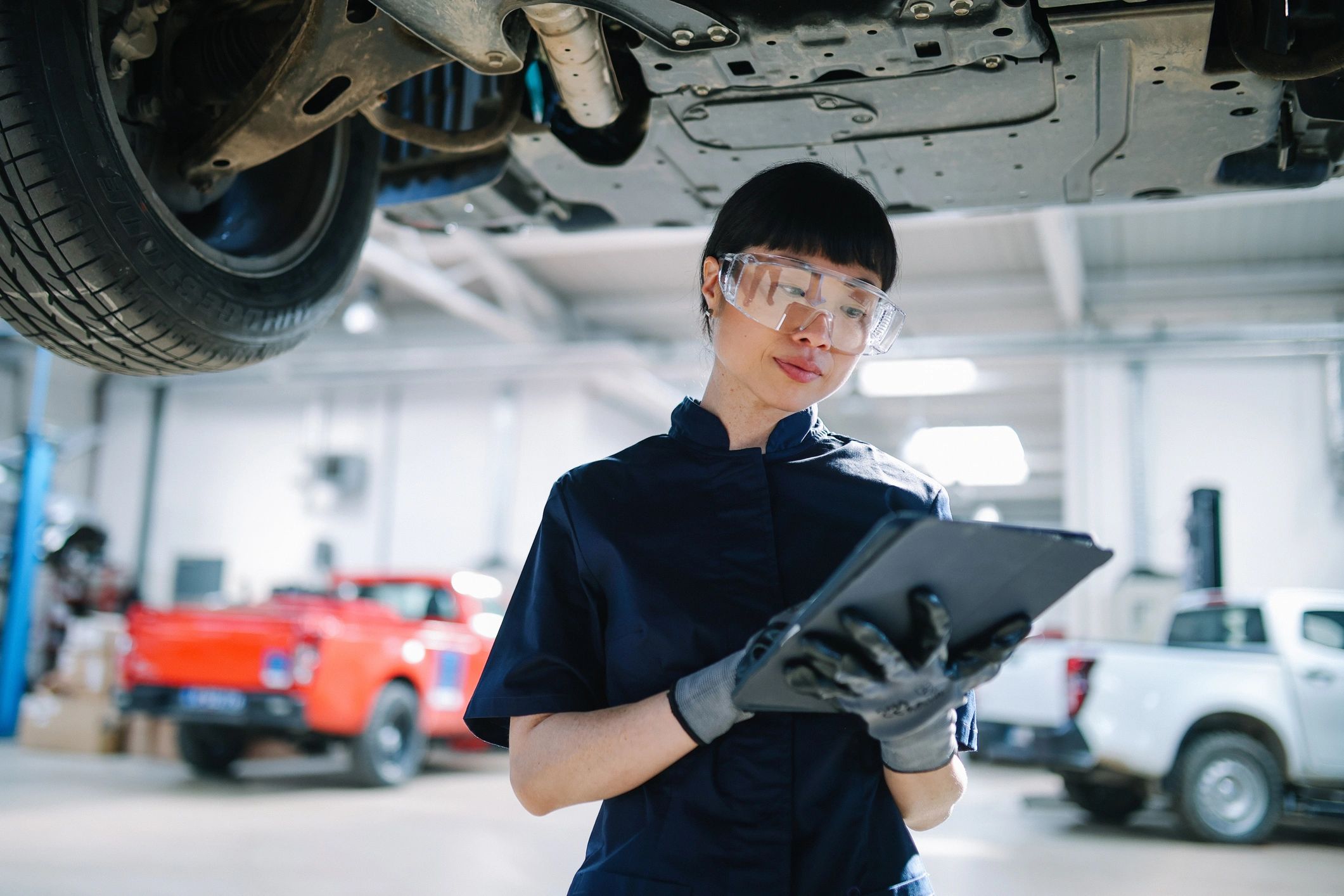 Technician performing diagnostics in a car repair shop