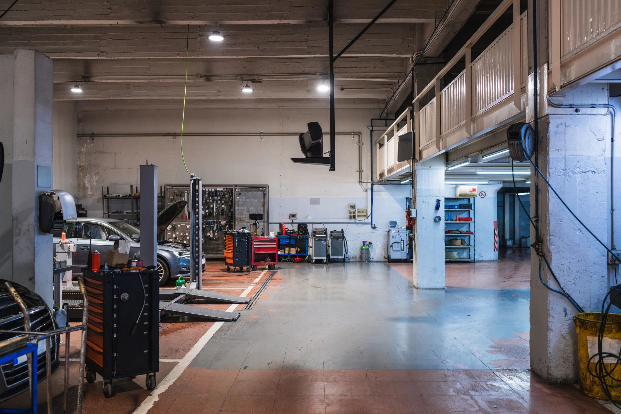 Modern auto repair shop service bay with lifts and toolboxes