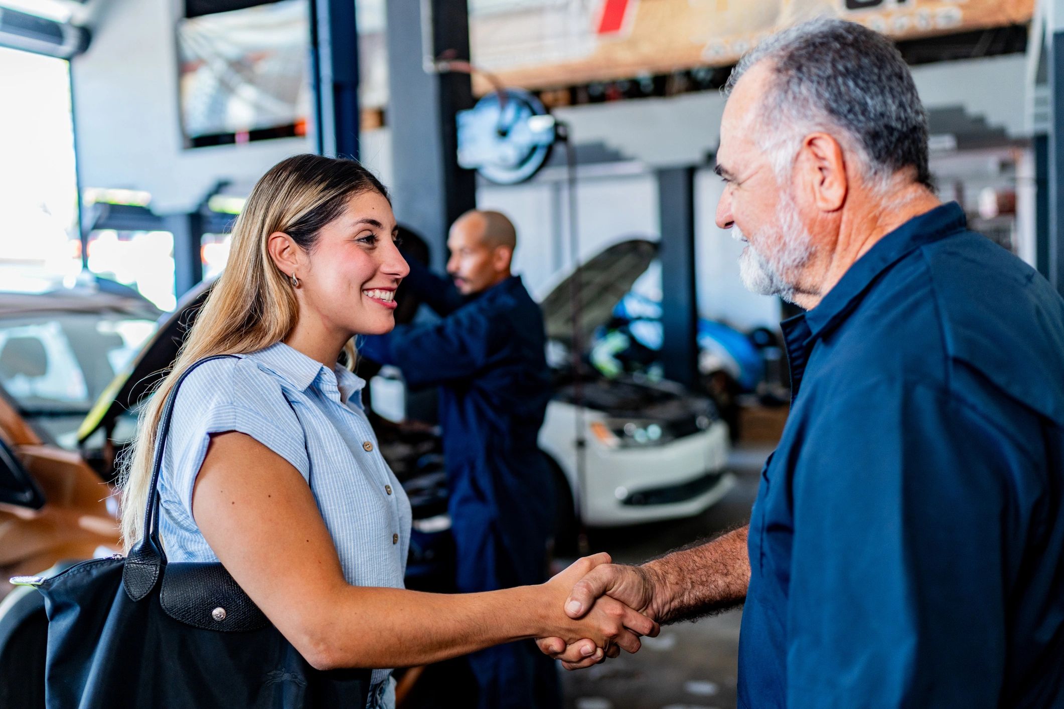Customer greeting a mechanic at an auto repair shop